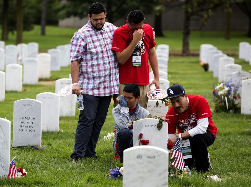 The family of Army Staff Sgt. Daniel A. Quintana gathers at his grave on Memorial Day in at...