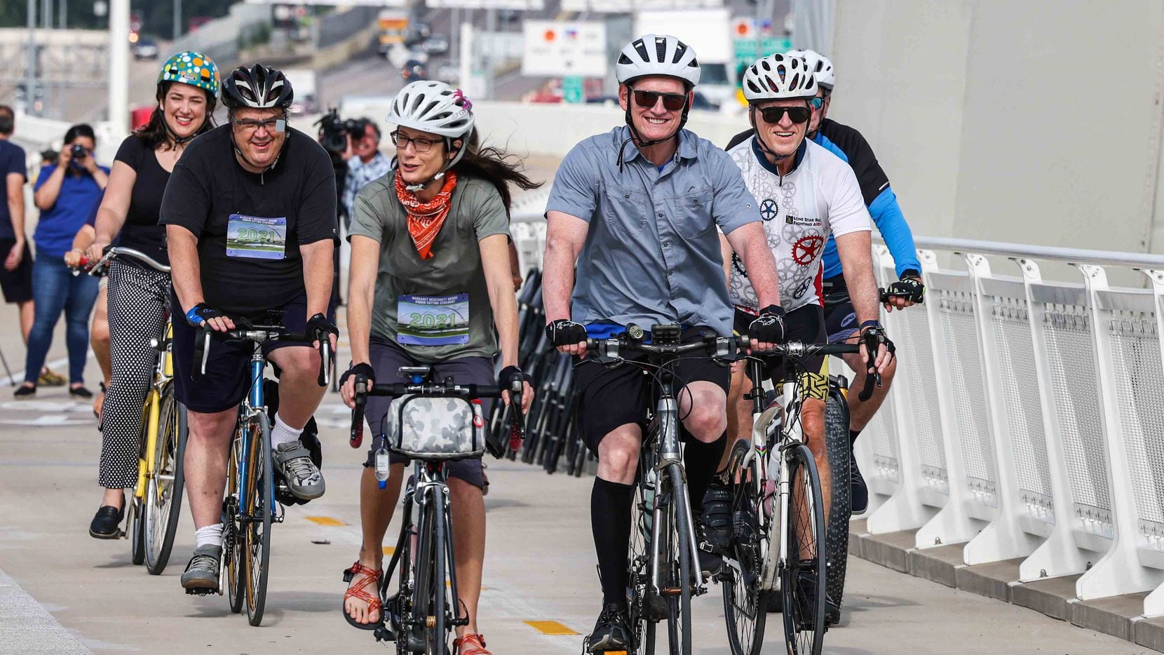 Dallas County Judge Clay Jenkins, along with a group of cyclists, ride their bikes during the opening of the eastbound and westbound pedestrian and bicycle bridges on the Margaret McDermott Bridge in Dallas on Thursday, June 10, 2021.