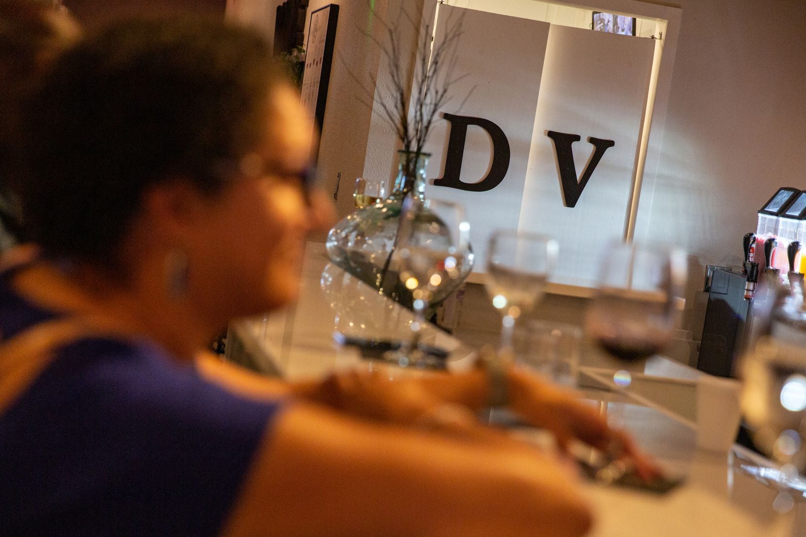 Courtney Haeflinger enjoys a glass of wine at the Distinctive Vines Wine Lounge, a wine bar...
