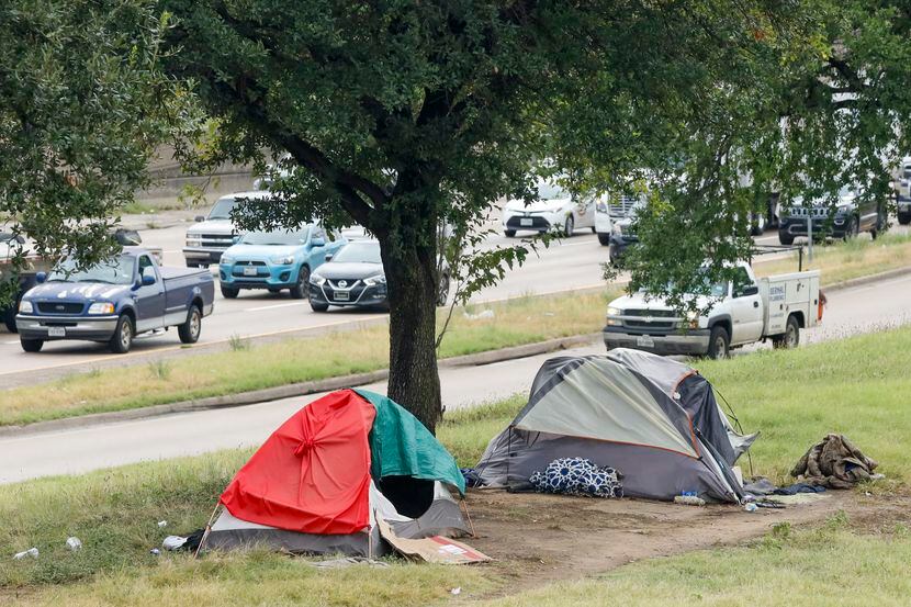 Tents served as makeshift housing against the rain Wednesday alongside Interstate 30 near...