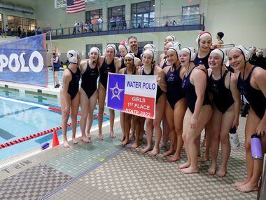 The Flower Mound team poses with the championship banner after defeating Southlake Carroll...