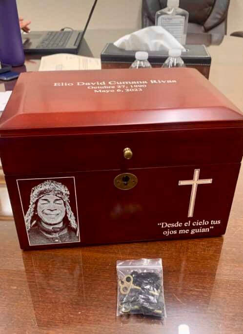The urn for Elio Cumana includes his photo and an inscription.