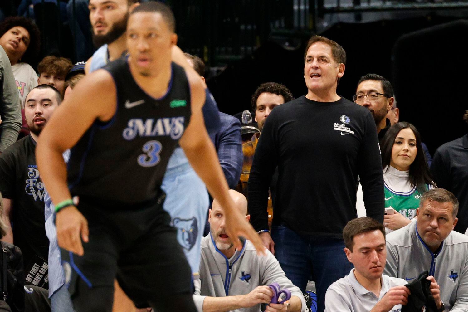 Dallas Mavericks owner Mark Cuban, right, watches his players during the first half of an...