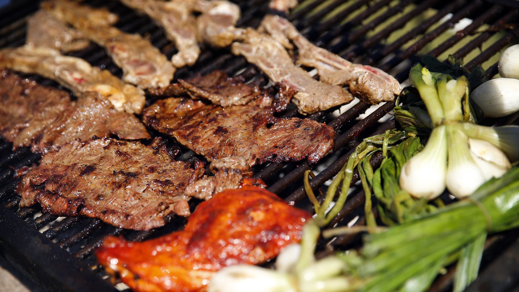 Dallas Cowboys fans grilled fajitas and tablitas at a tailgate party outside AT&T Stadium...