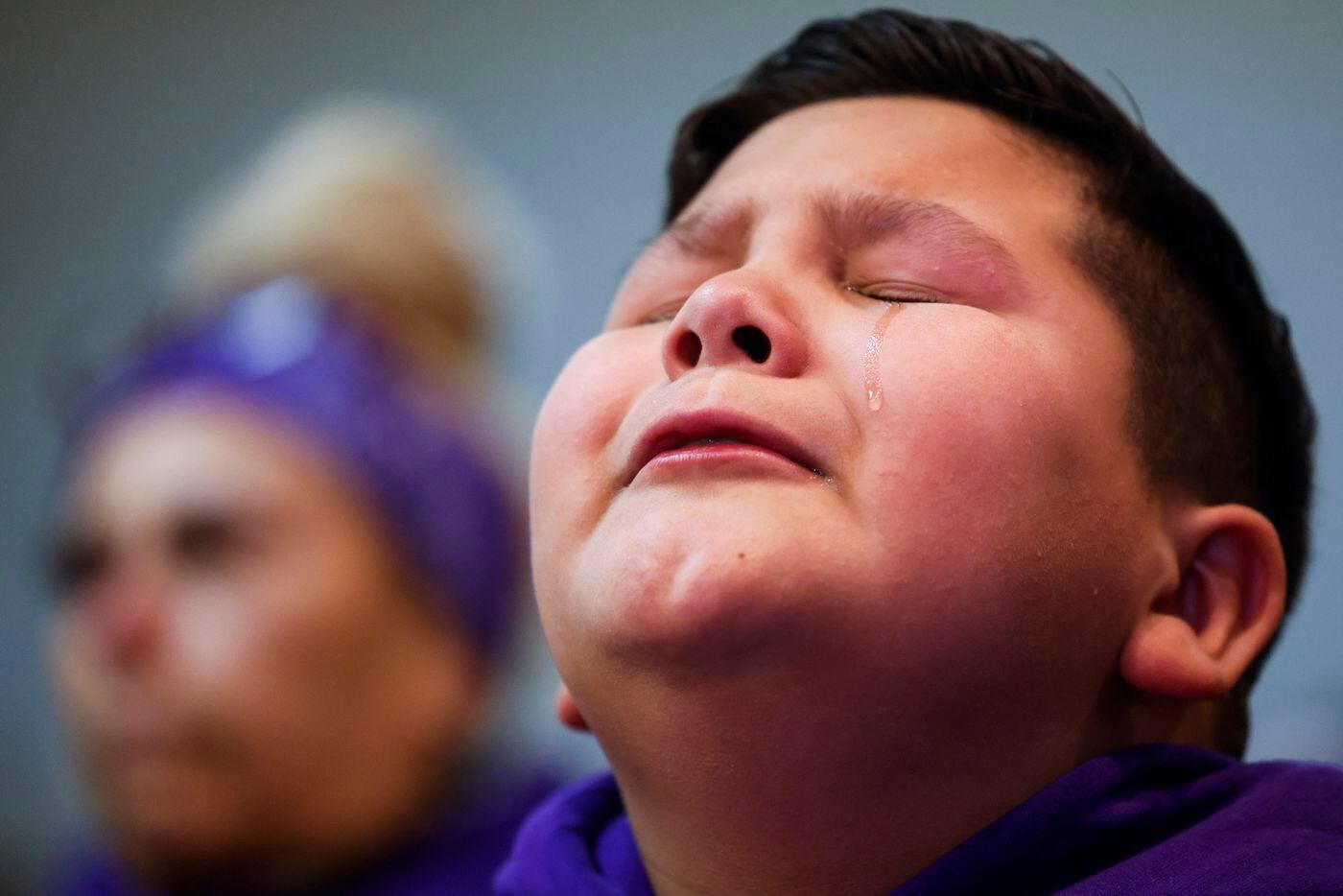 A tear drop rolls down the cheek of Ayden Robles, 10, step brother of late Grabiel Zamora,...