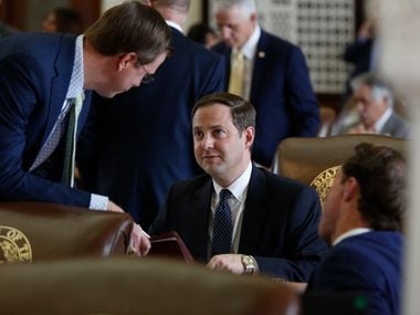 Rep. Will Metcalf, R-Conroe, talks with Rep. Dustin Burrows, R-Lubbock, in the Texas House of Representatives chamber. (James Gregg/Austin American-Statesman)