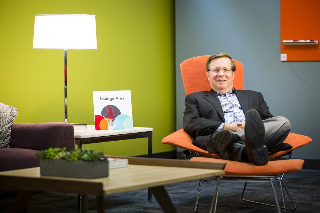  Jim Lentz, CEO of Toyota North America, stretches out in a model lounge area at Toyota's...