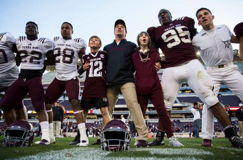 Texas A&M Aggies head coach Jimbo Fisher, center, sings the school song with his team after...