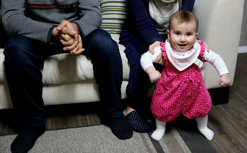 Sidra Jawish, 9 months old, plays while her parents, Syrians Moustafa Jawish and Reem Khero,...