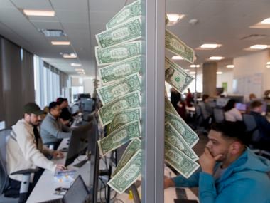 A "dollar tree" in the Uber Eats section at the company's Deep Ellum office on Jan. 27, 2020 in Dallas. A dollar gets added to the post each time the team closes a "three pointer account." (Juan Figueroa/ The Dallas Morning News)