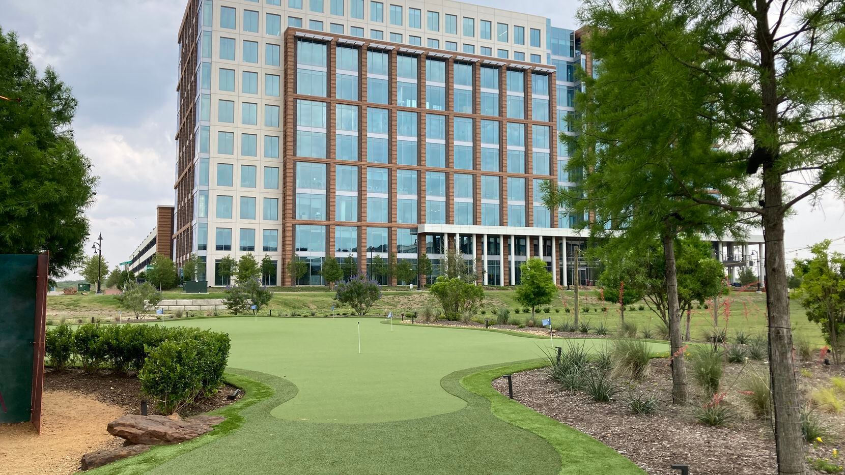 A new putting green is in front of the first high-rise office built in Billingsley Co.'s...