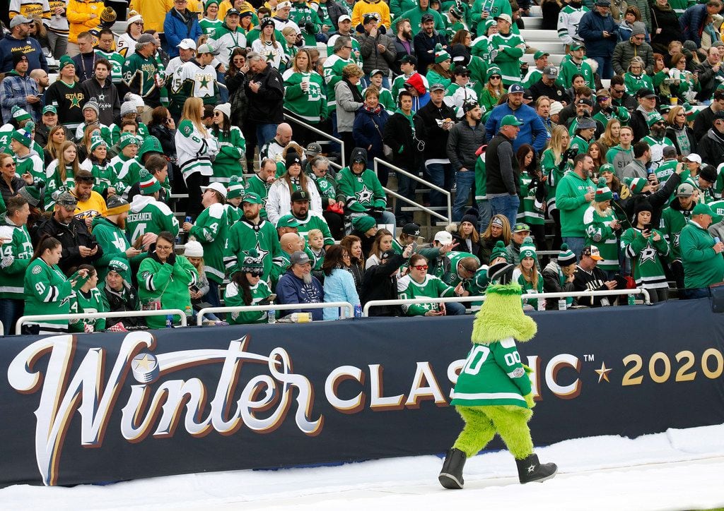 Dallas Stars mascot Victor E. Green races past a the stands before their outdoor NHL Winter...