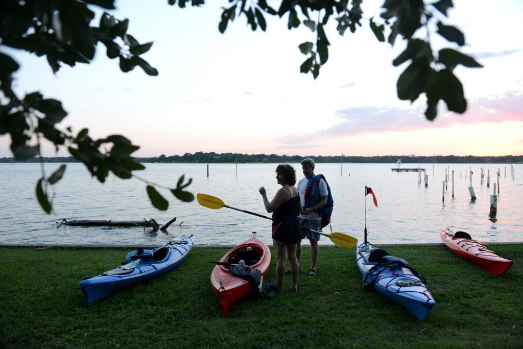 Kayakers with the Dallas Downriver Club for a moonlight paddle at White Rock Lake in Dallas...