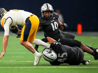 Highland Park quarterback Brennan Storer (7) fumbles as he is brought down by Denton Guyer...