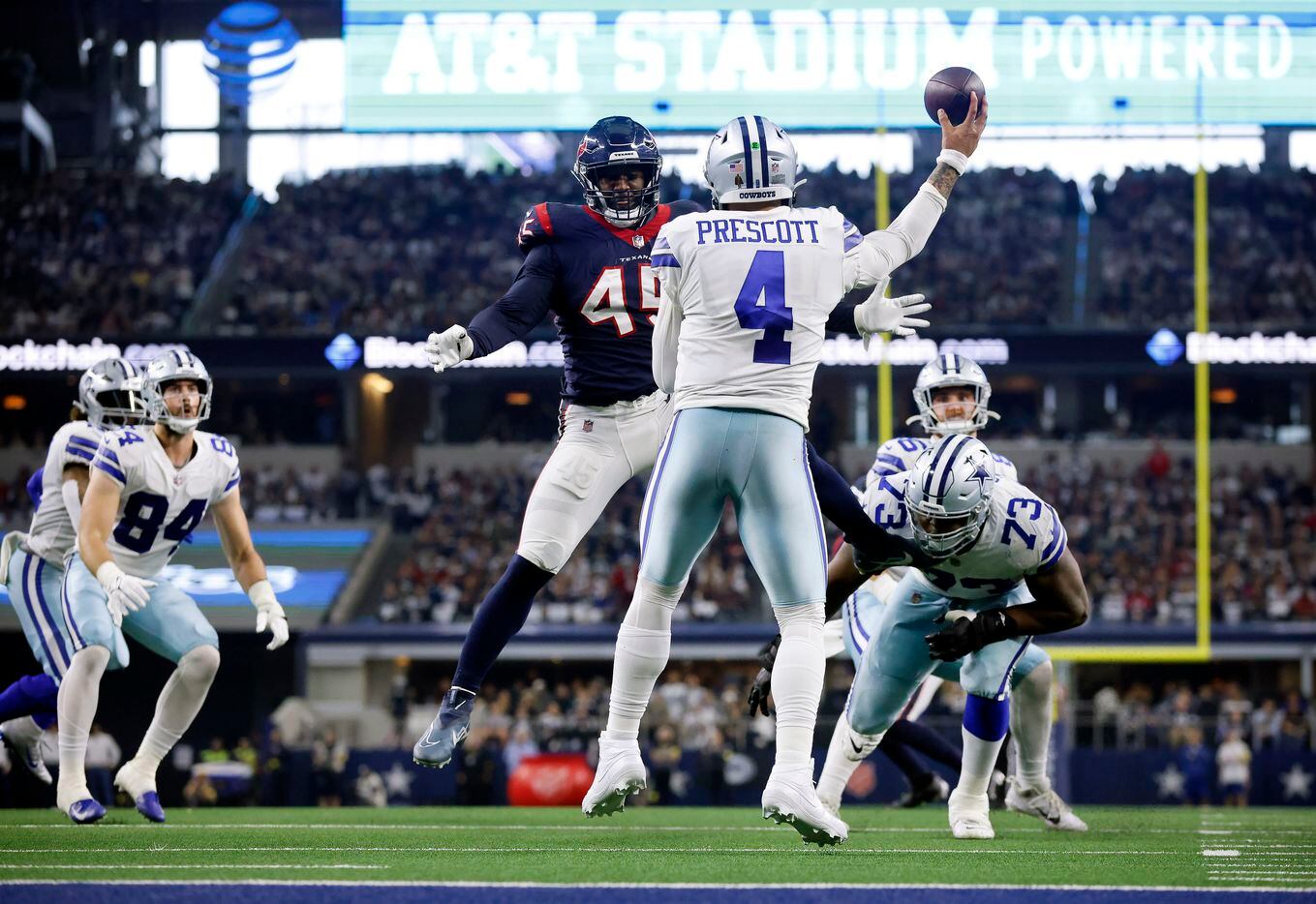Dallas Cowboys quarterback Dak Prescott (4) throws a pass around Houston Texans linebacker...