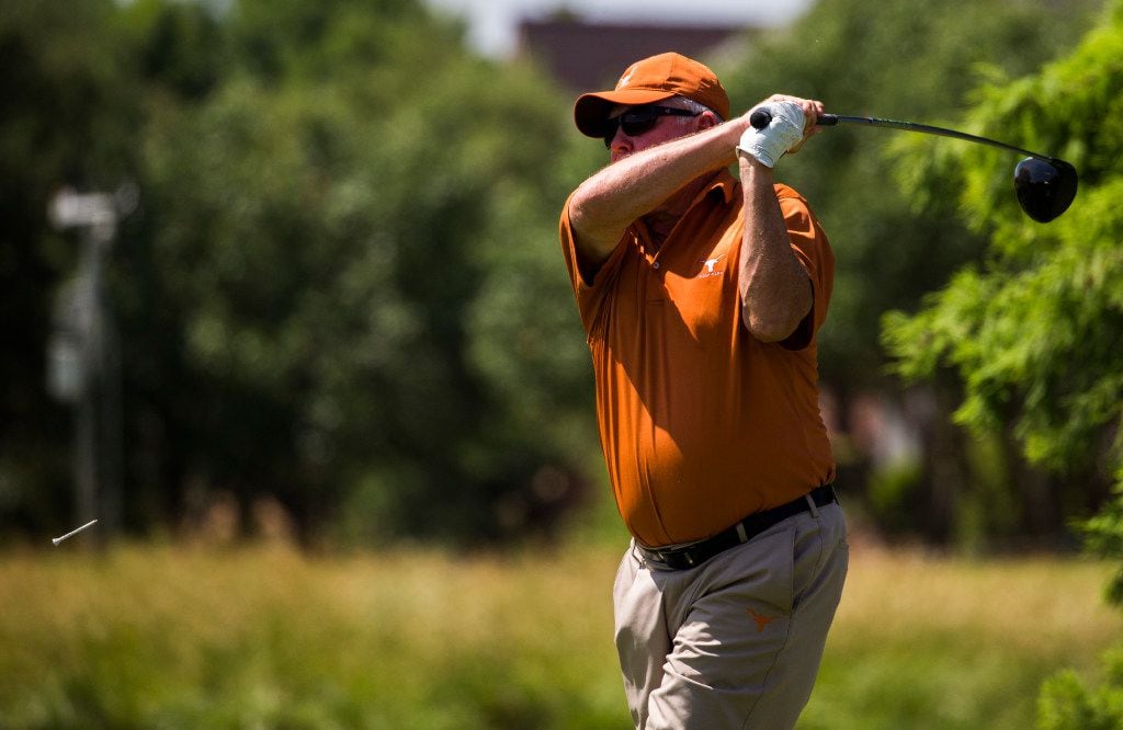 Former University of Texas football coach Mack Brown tees off at the ninth hole during the...