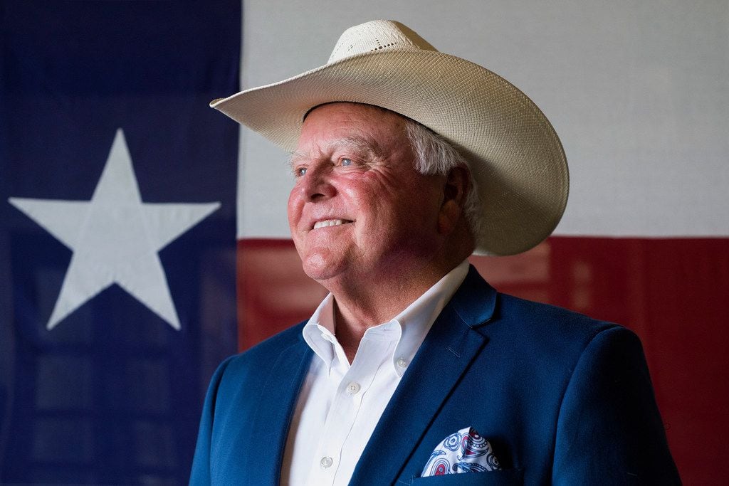 Texas Agriculture Commissioner Sid Miller stands in front of a Texas flag at Renard Group...