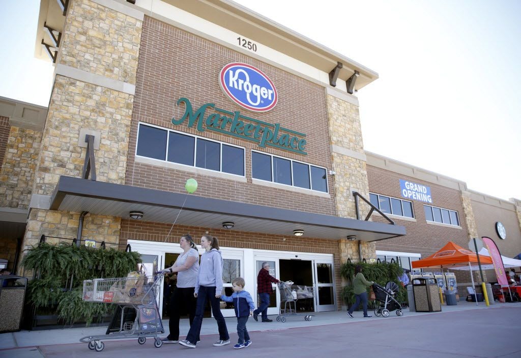 Shoppers walk through the entrance of the Kroger Marketplace in Prosper.