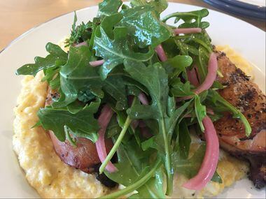 The yardbird and grits at The Market at Bonton Farms includes a char-broiled hind chicken...