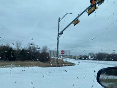 A light covering of ice coats the road near the Grapevine Mills Parkway exit at North 2499
