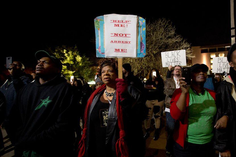 People protest against the Fort Worth Police Department at the Tarrant County Courthouse in...