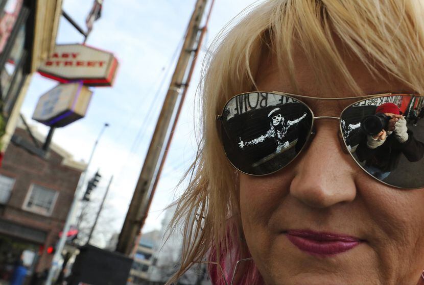 Photographer and author Karen Mason Blair's sunglasses reflect the late Andrew Wood of rock...