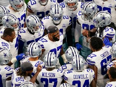 Dallas Cowboys players huddle around defensive end Everson Griffen (97) before an NFL football game against the Atlanta Falcons at AT&T Stadium on Sunday, Sept. 20, 2020, in Arlington.
