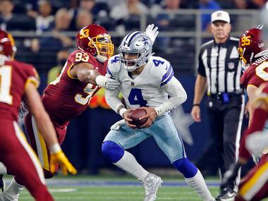 Dallas Cowboys quarterback Dak Prescott (4) tries to elude blitzing Washington Football Team...