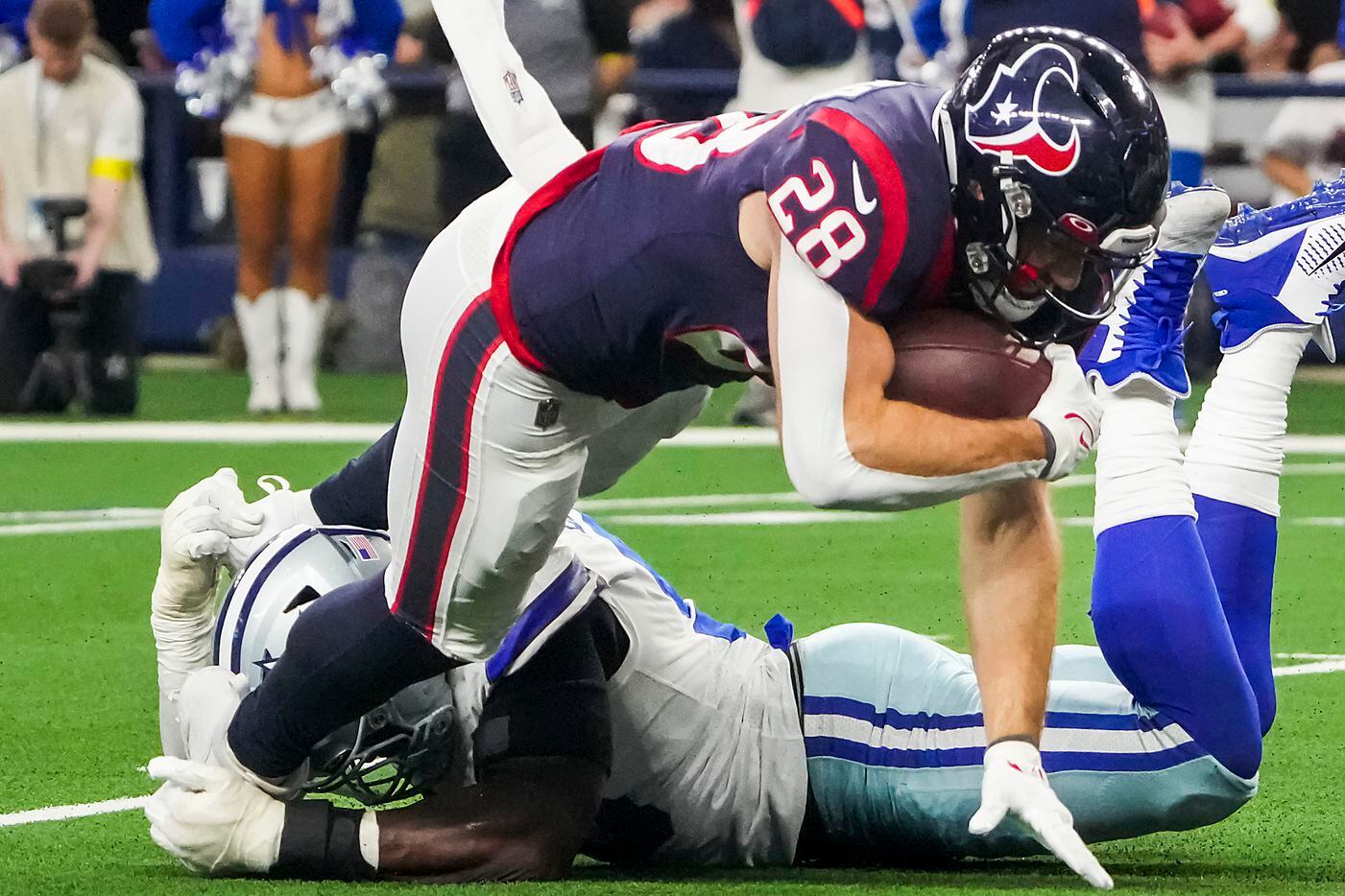 Houston Texans running back Rex Burkhead (28) is stopped for a loss by Dallas Cowboys...