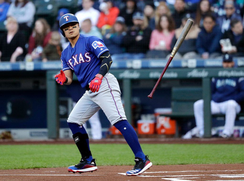 Texas Rangers' Shin-Soo Choo tosses aside his bat after walking against the Seattle Mariners...