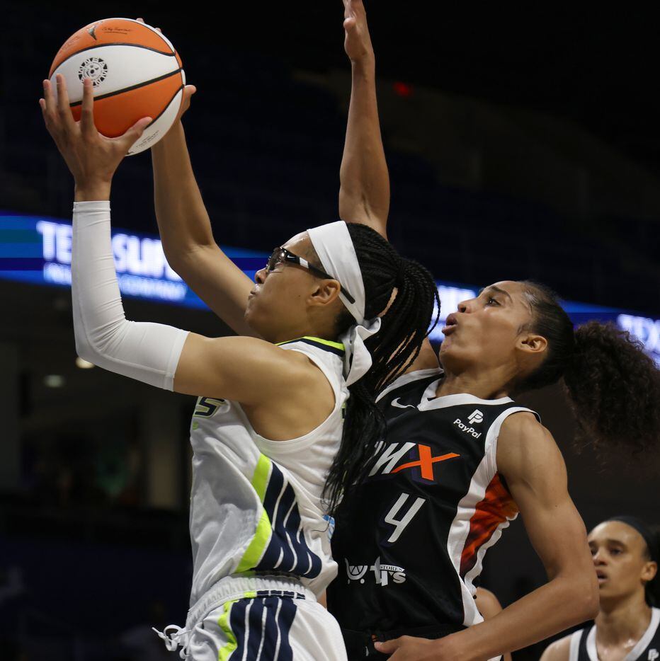 Dallas Wings guard Allisha Gray (15) drives to the basket as she is defended by Phoenix...