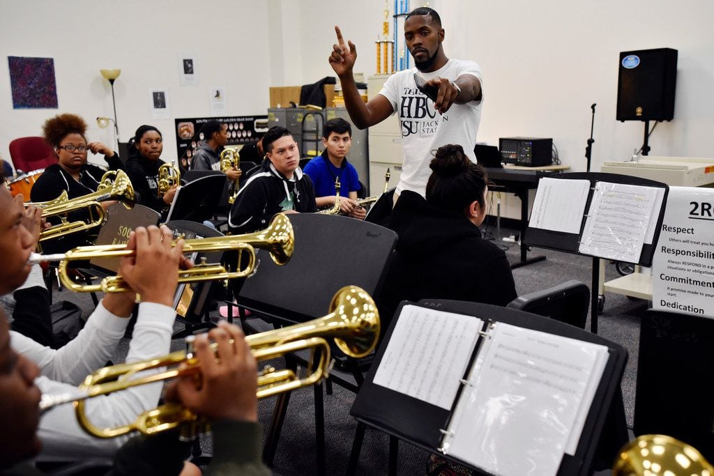 Band co-director Markell Hall works with band students as teachers prepared their classrooms...