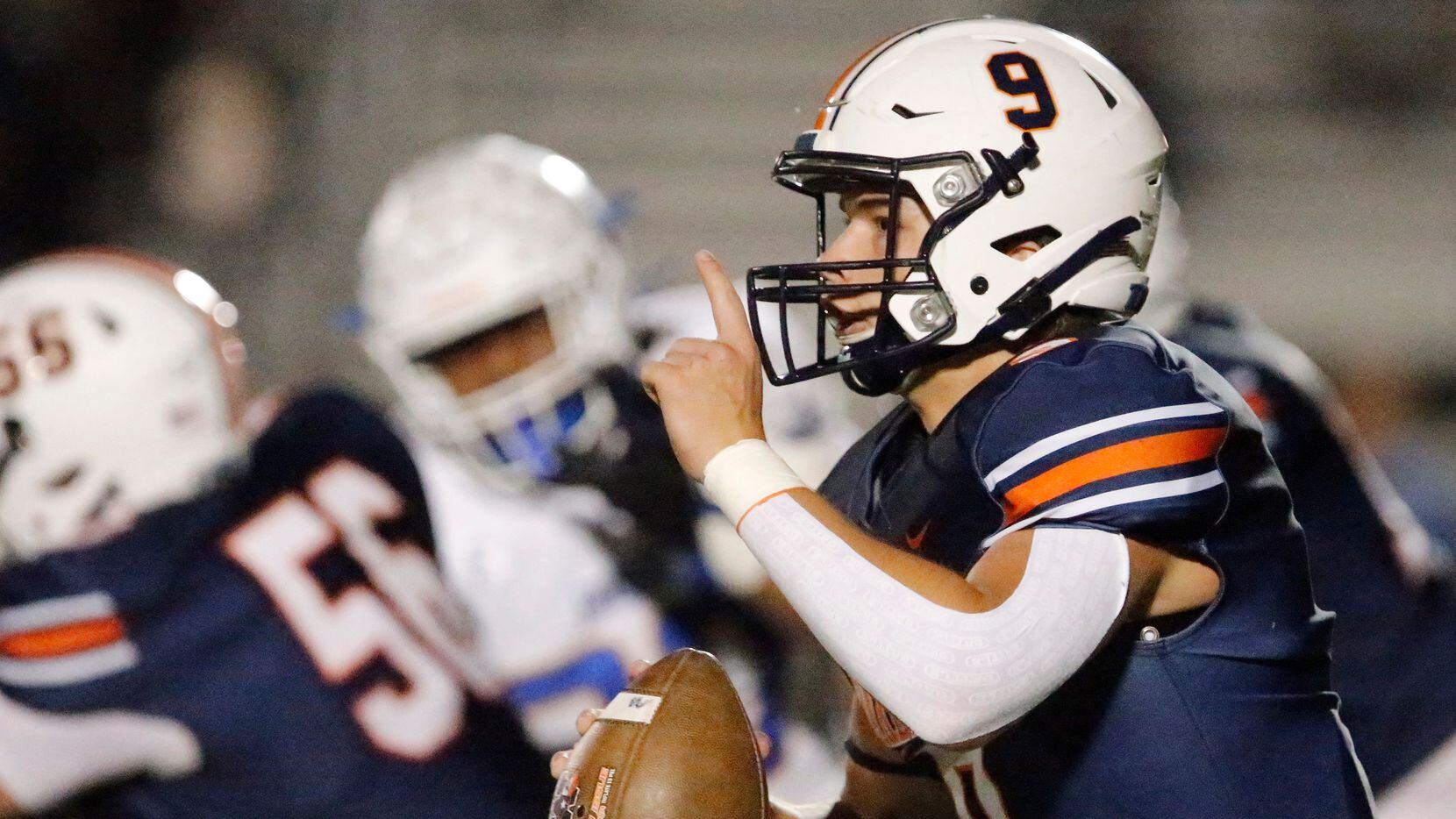Wakeland High School quarterback Brennan Myer (9) signals his receiver on the run during the...