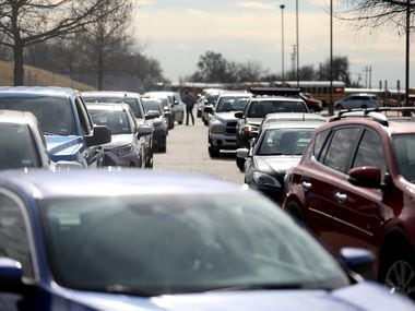 Lines of cars at at a COVID-19 testing center at Kuykendall stadium in Frisco, Texas, Tuesday, January 11, 2022. 