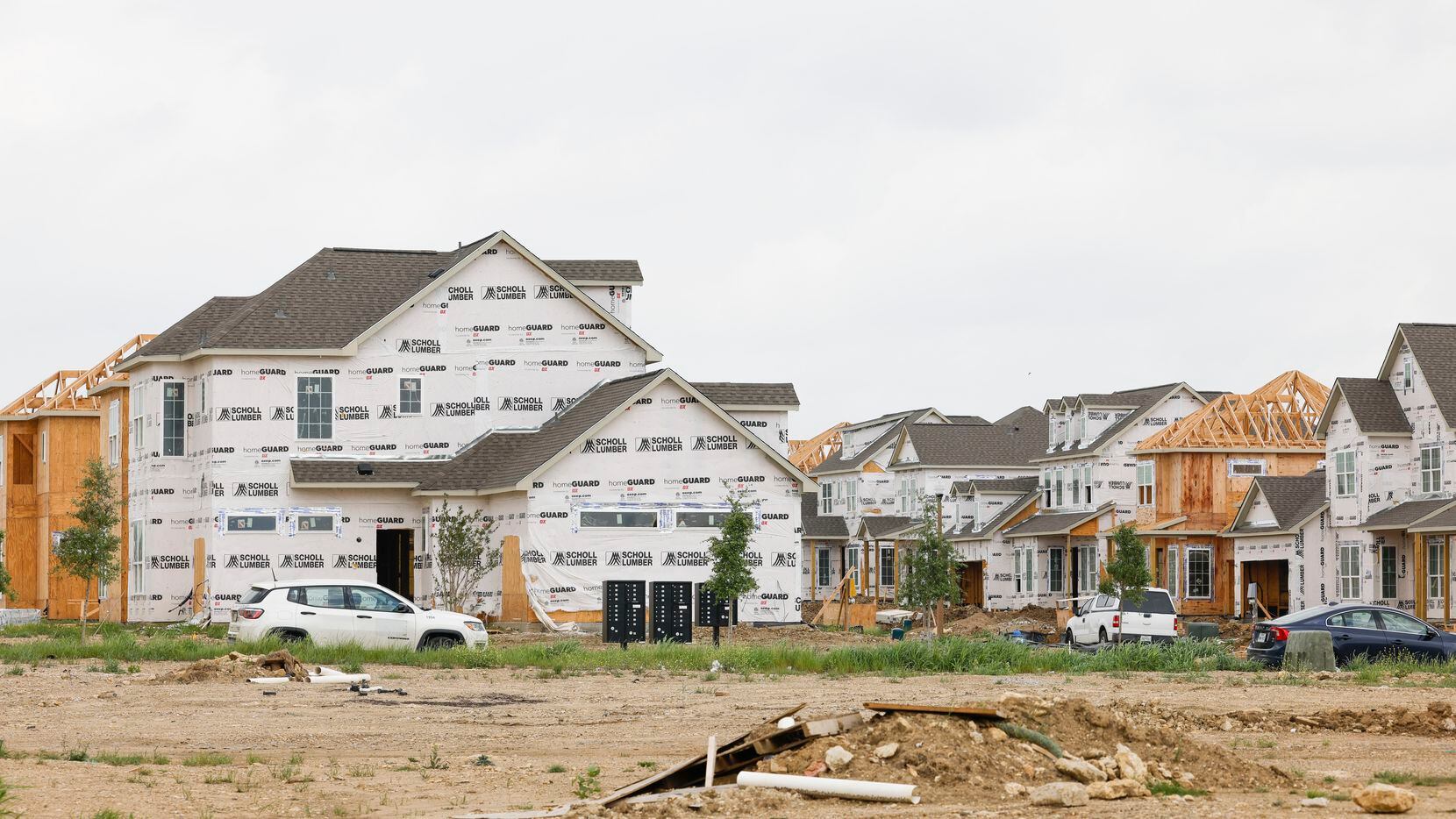 Rental townhomes and single-family houses are shown under construction at the Residences at...