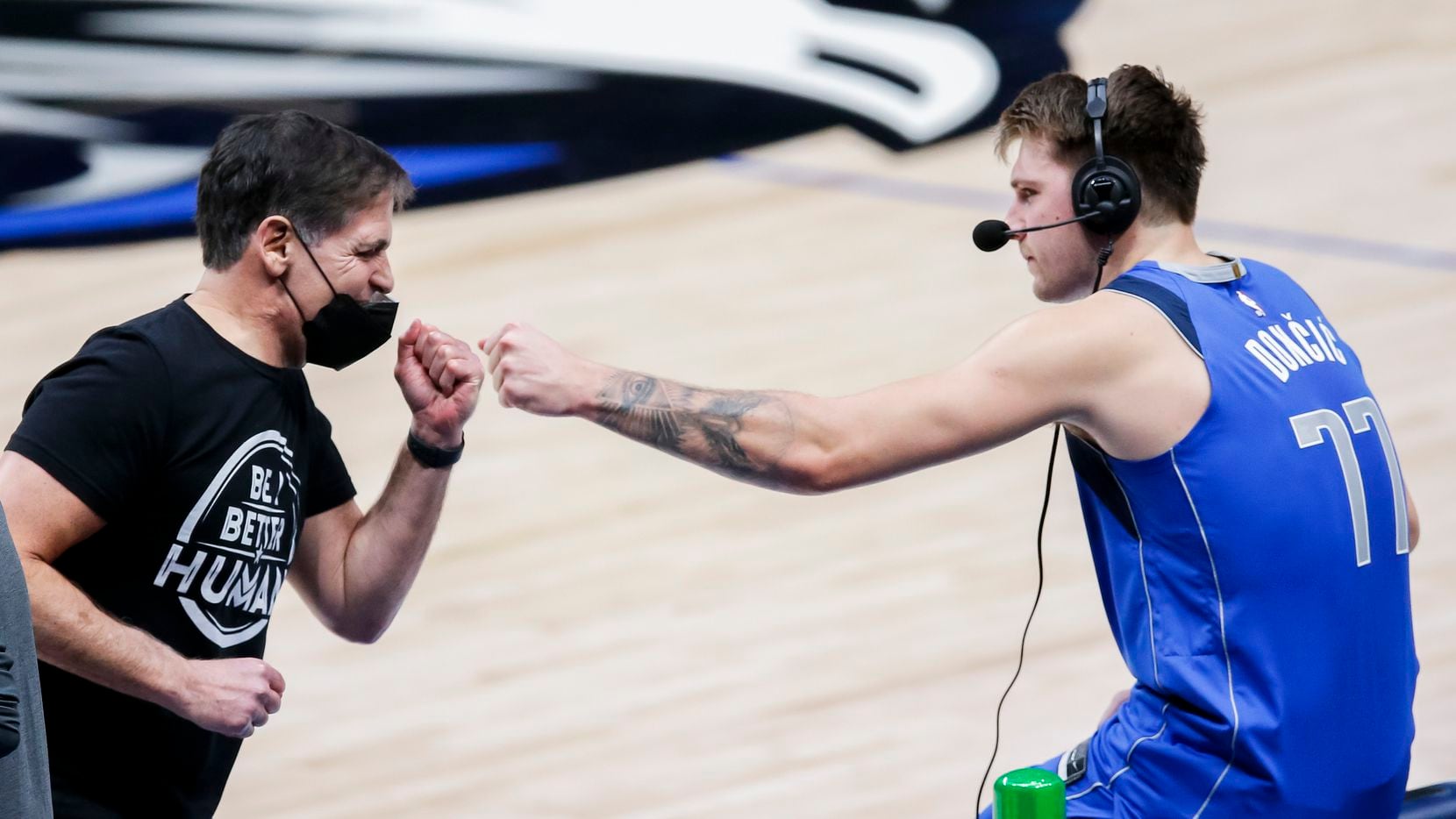 Mavericks owner Mark Cuban fist bumps guard Luka Doncic (77) after a 118-117 win against the...