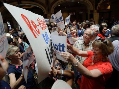 Supporters of Texas Gov. Greg Abbott and protesters stand off prior to an event where Abbott...