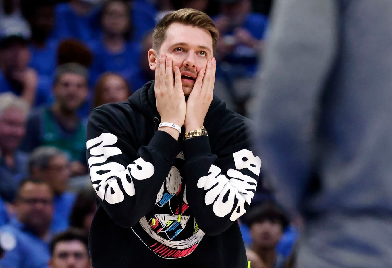 Injured Dallas Mavericks guard Luka Doncic reacts to a second half call in Game 1 of an NBA...