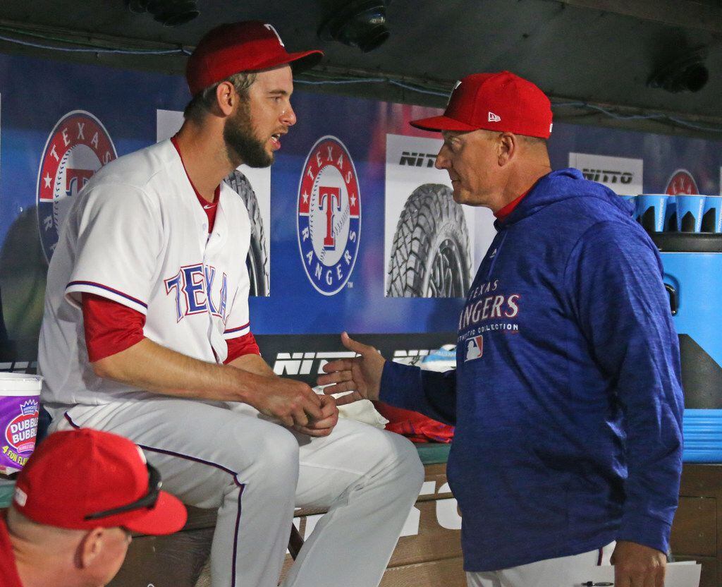 Texas Rangers manager Jeff Banister, right, talks with reliever Chris Martin (31) after his...