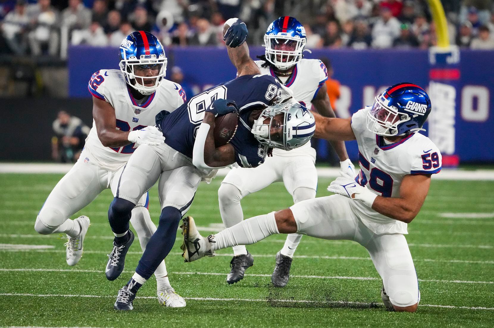 Dallas Cowboys wide receiver CeeDee Lamb (88) is brought down by New York Giants linebacker...