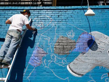Dallas-based Muralist Isaac "IZK" Davies paints a mural of the famous Nolan Ryan punch scene...