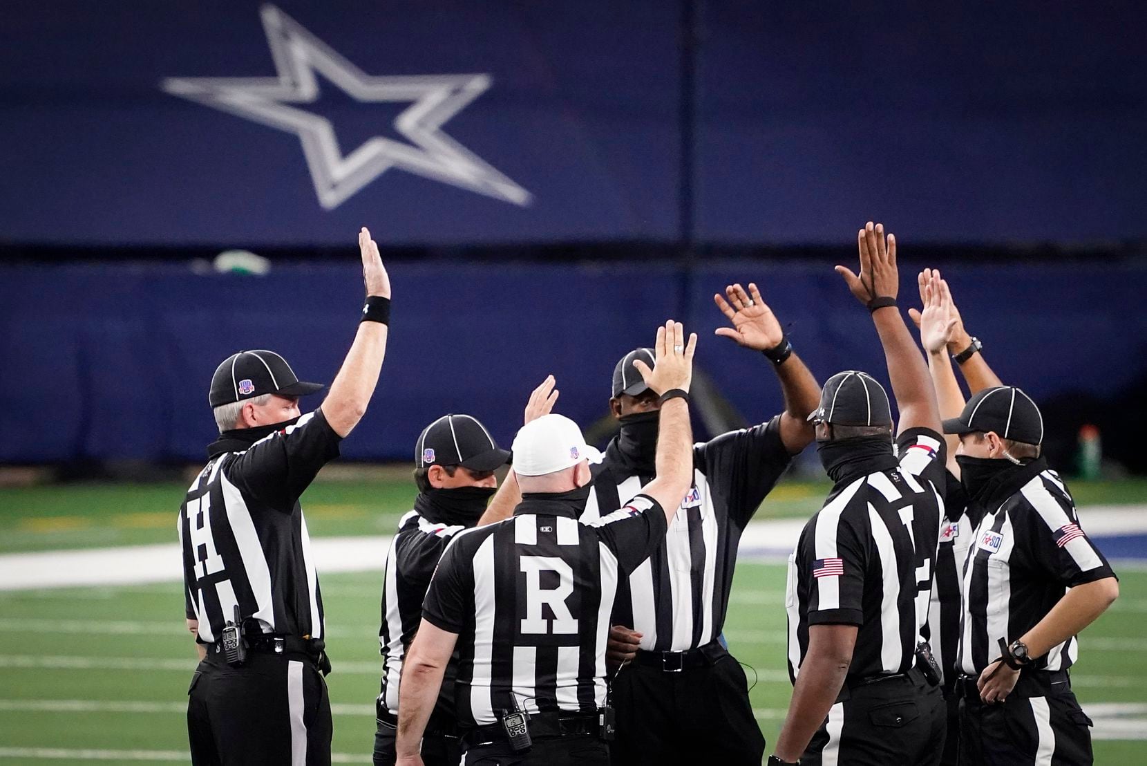 Officials huddle before the Class 5A Division I state football championship game between Denton Ryan and Cedar Park at AT&T Stadium on Friday, Jan. 15, 2021, in Arlington, Texas. (Smiley N. Pool/The Dallas Morning News)