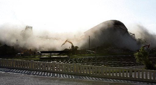  A demolition worker jumps for cover as the roof of Reunion Arena collapses on Nov. 17, 2009. 