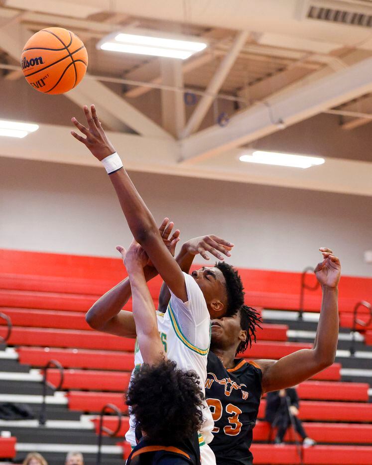 W.T. White forward PJ Washington (23) fouls Madison forward Quintin Spencer (13) on a shot attempt during the third quarter of a Dallas ISD Holiday Invitational basketball tournament game at Woodrow Wilson High School in Dallas, Tuesday, Dec. 28, 2021.