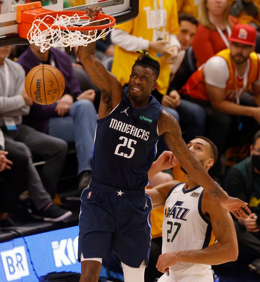 Dallas Mavericks forward Reggie Bullock (25) dunks the ball as Utah Jazz center Rudy Gobert...