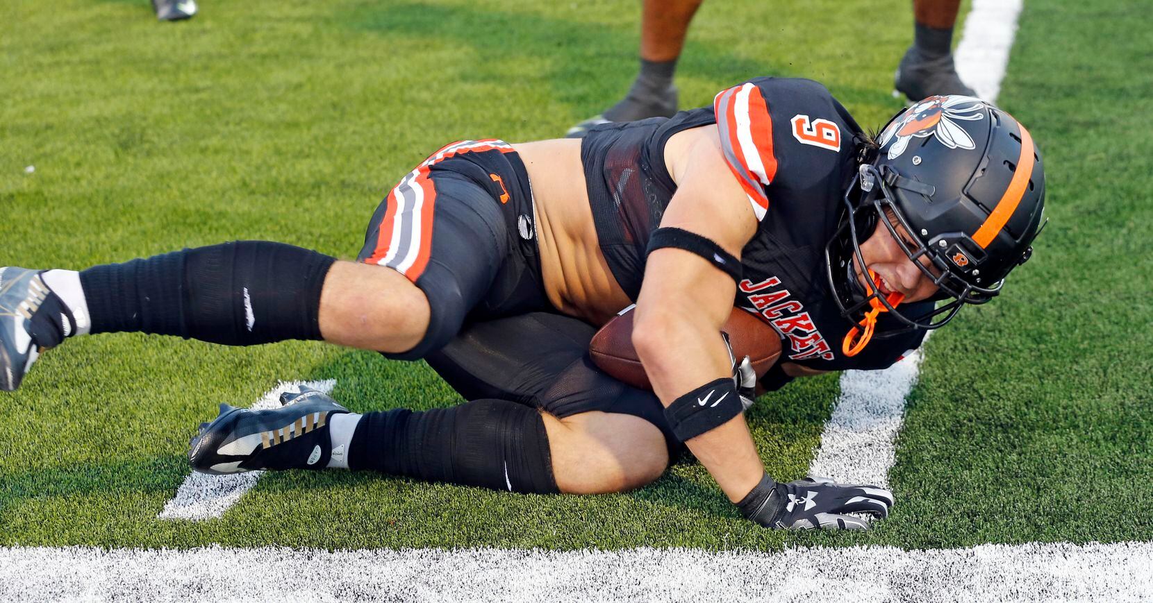 Rockwall High’s  Jarrett Stoner (9) falls on a loose kickoff ball during the first half of a...