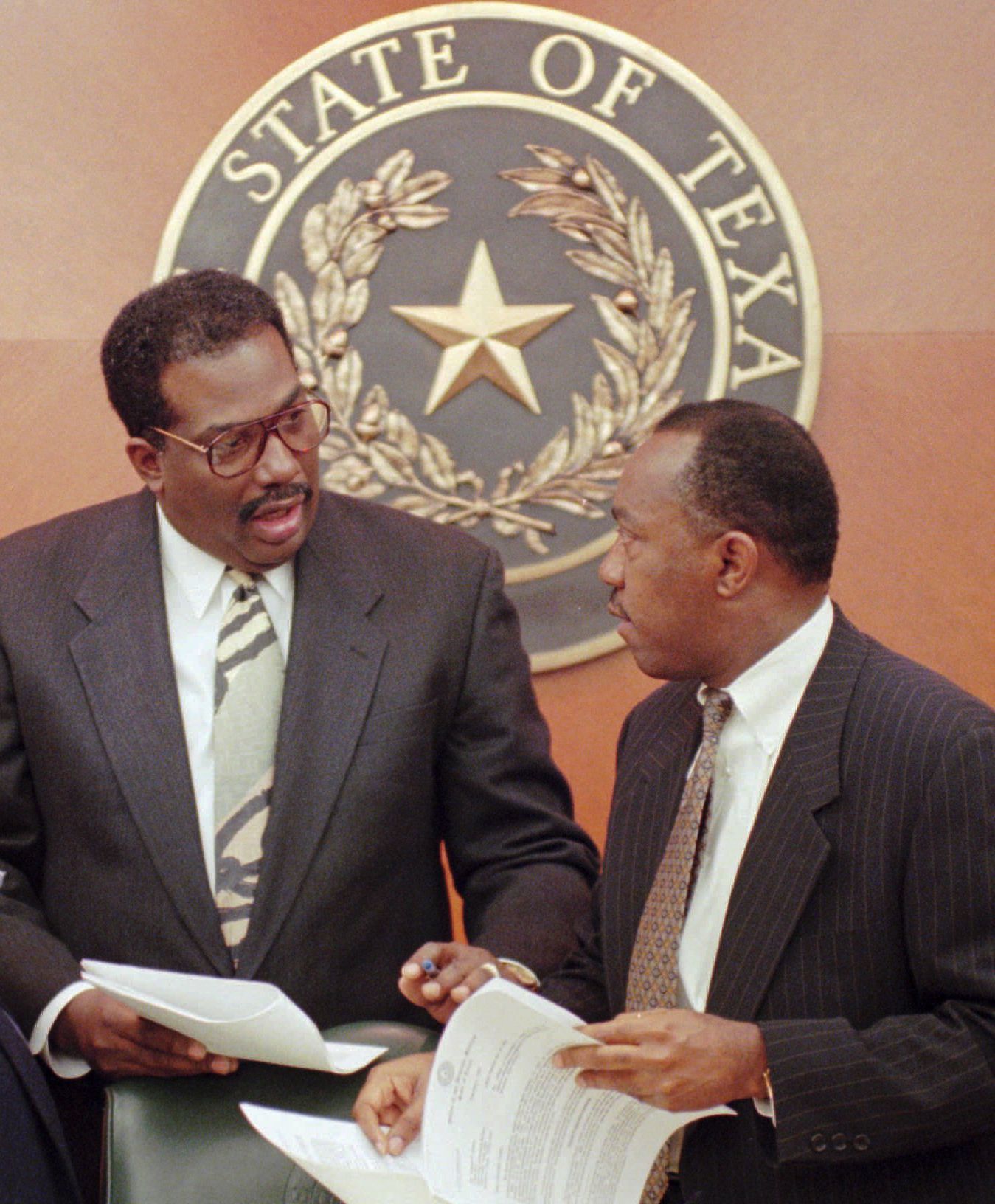 ORG XMIT: AT103 Sen. Royce West, D-Dallas, center, talks with Rep. Irma Rangel, D-Kingsville, left, and Rep. Sylvester Turner, D-Houston, before a House committee hearing Thursday, Feb. 6, 1997, in Austin, Texas. Attorney General Dan Morales testified before the committee on his recent affirmative action ruling at Texas colleges and universities. (AP Photo/George Bridges)