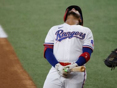 Texas Rangers designated hitter Willie Calhoun reacts after being hit on the left wrist by a pitch during the second inning of a baseball game against the Kansas City Royals, Saturday, June 26, 2021, in Arlington, Texas. (AP Photo/Michael Ainsworth)