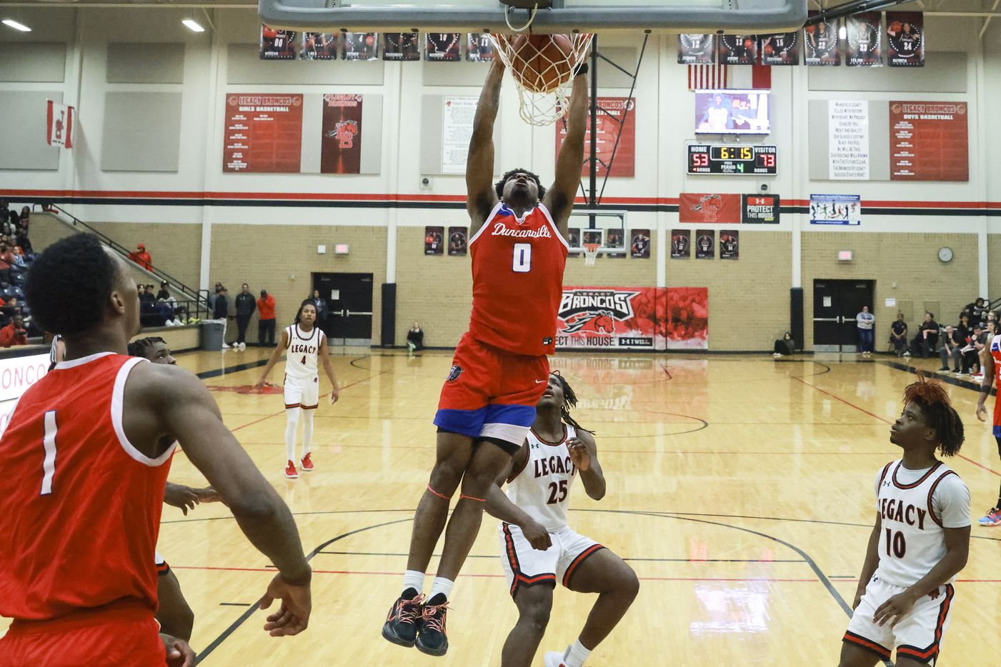 Duncanville High School’s K.J. Lewis (0) dunks during a game against Mansfield Legacy High...