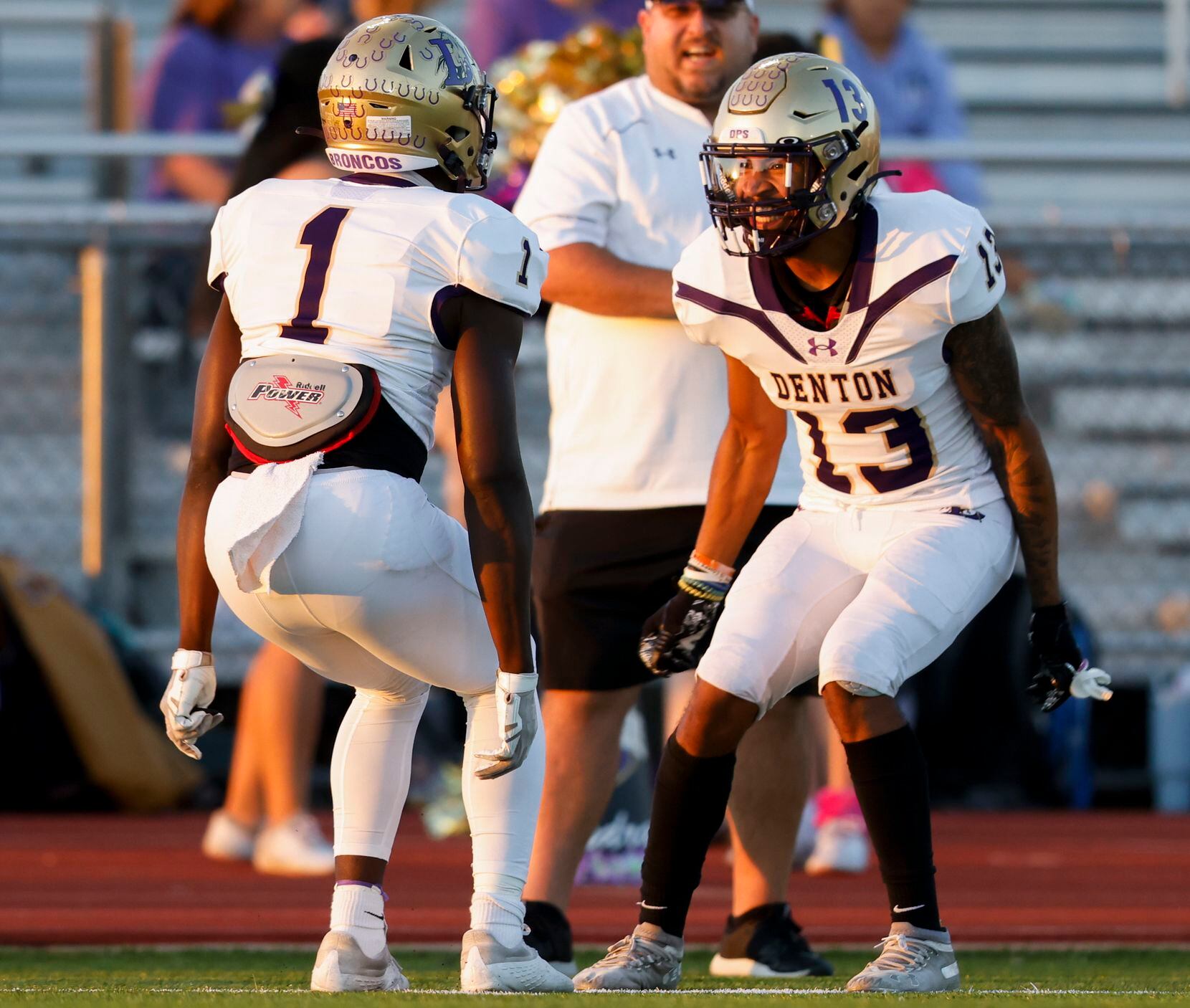 Denton’s running back Coco Brown (1) celebrates with teammate strong safety Jason Smith (13)...